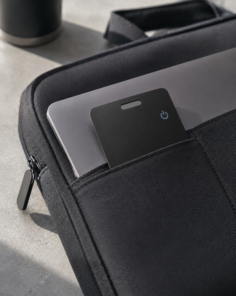 Tracking card in the sleeve pocket beside a laptop