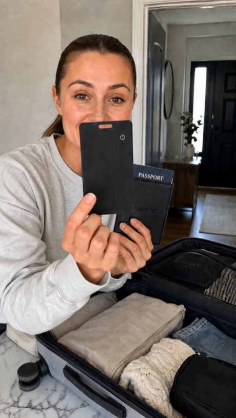 Customer packing a suitcase, sliding the card into a pocket